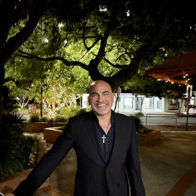 Brian Fabiano in an all-black suit at night