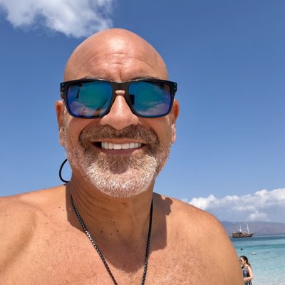 Brian Fabiano at the beach with the sea behind him