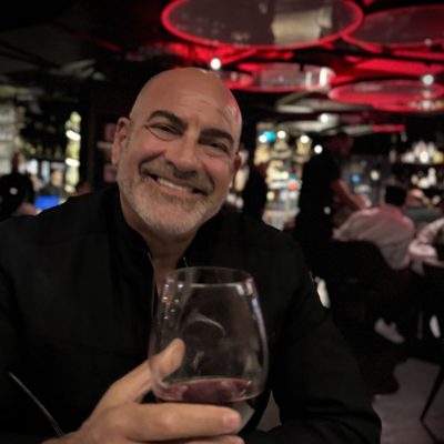 Brian Fabiano raising a glass of red wine