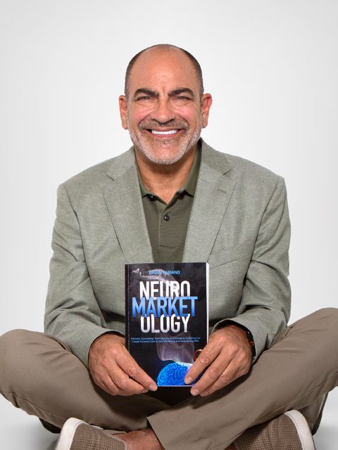Brian Fabiano, CEO of FabCom, holding his book Neuromarketology