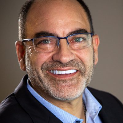 Studio headshot of Brian Fabiano in glasses and a dark blazer